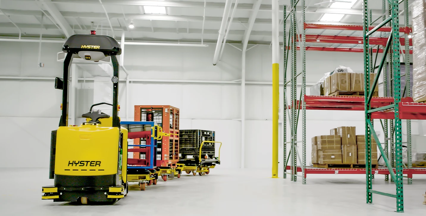 Hyster Atlas automated tow tractor pulling multiple carts.   
