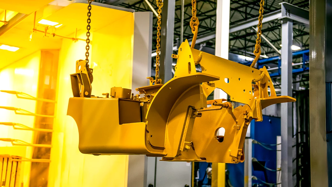 Forklift chassis exiting paint booth.