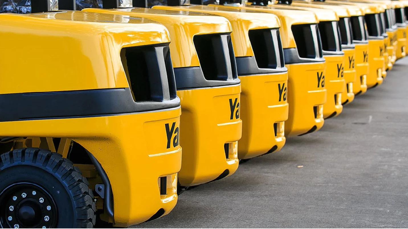 A series of lift trucks lined up.