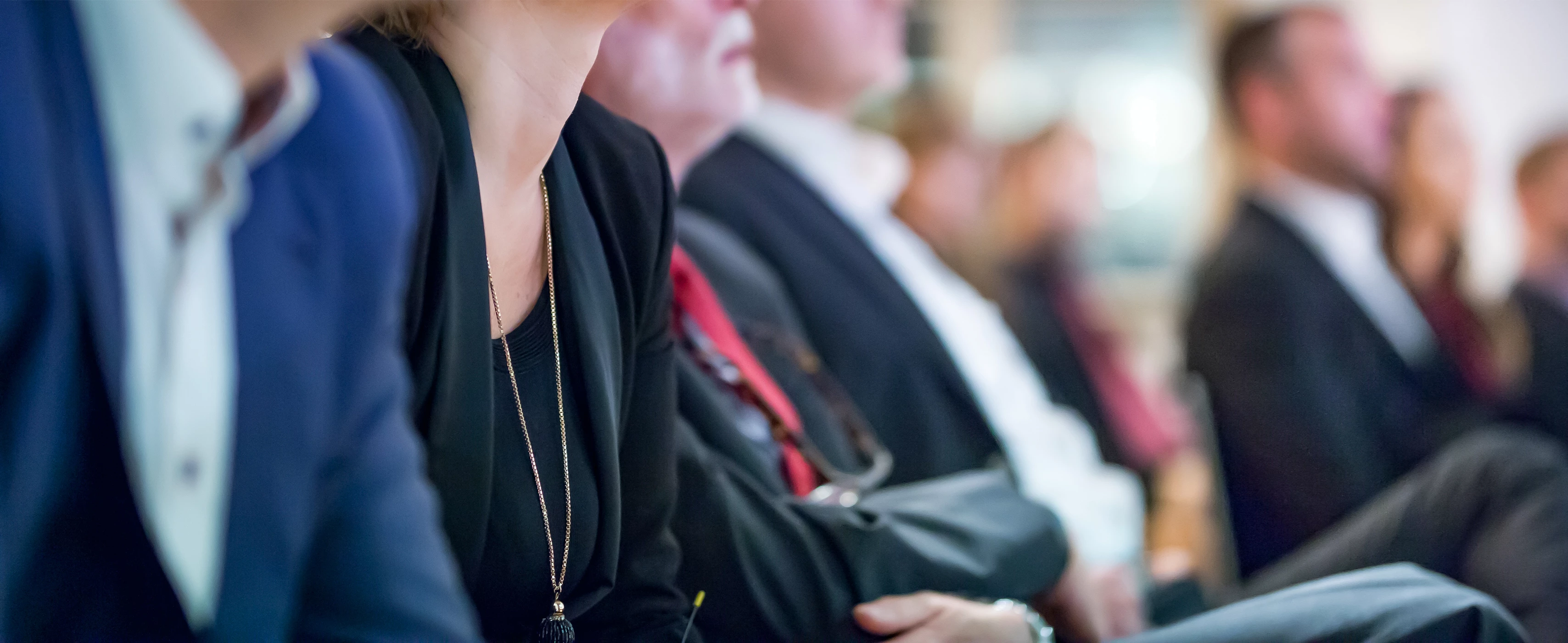 Row of executives sitting together.