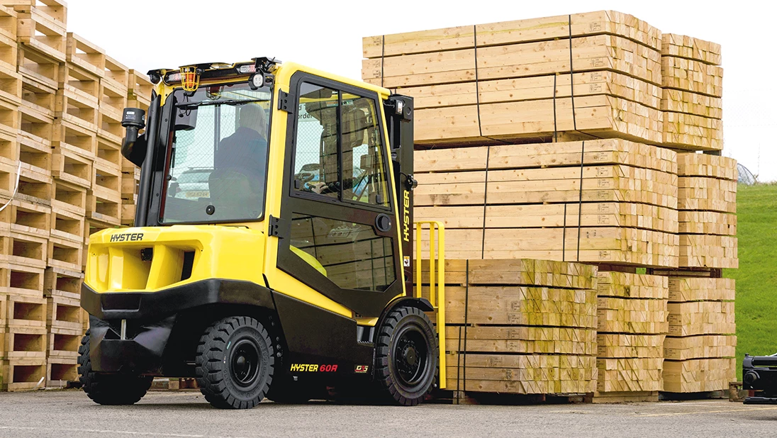 Hyster A Series truck lifting a pallet of lumber.
