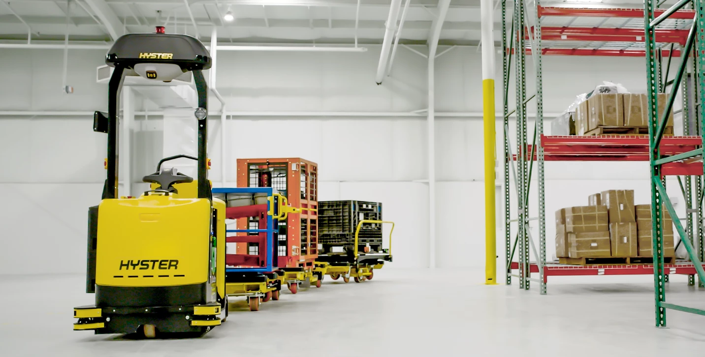 Hyster Atlas automated tow tractor pulling load. 