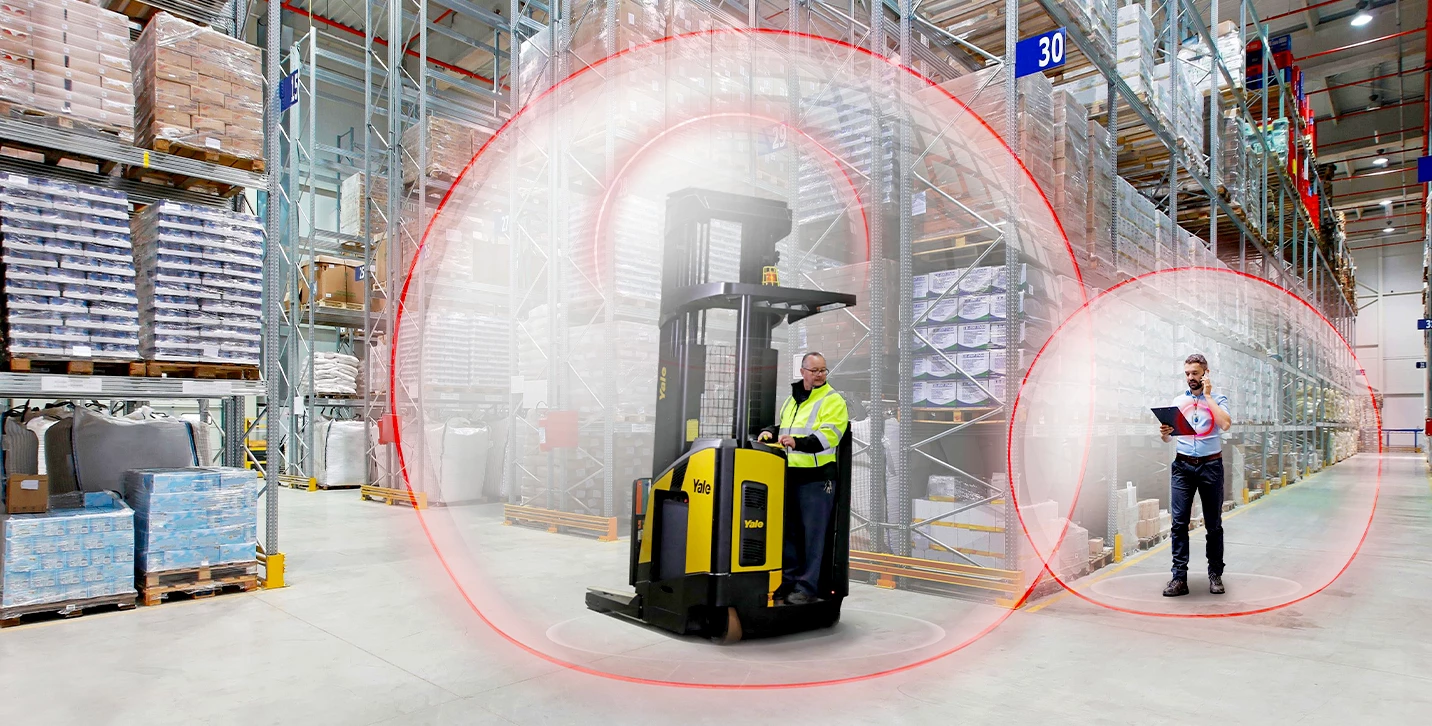 Reach truck with Yale Reliant operator assist system slowing as nears pedestrian.